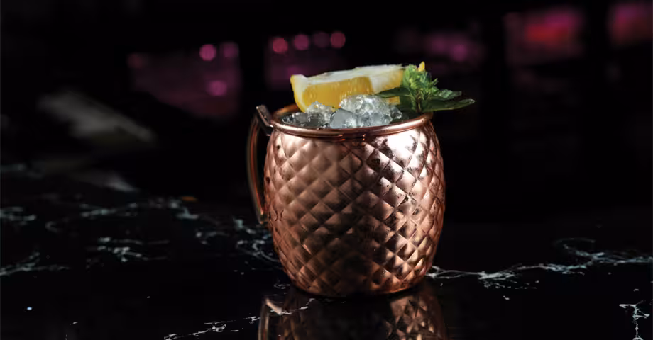 a copper mug of mule mocktail with ice cubes and lime garnish